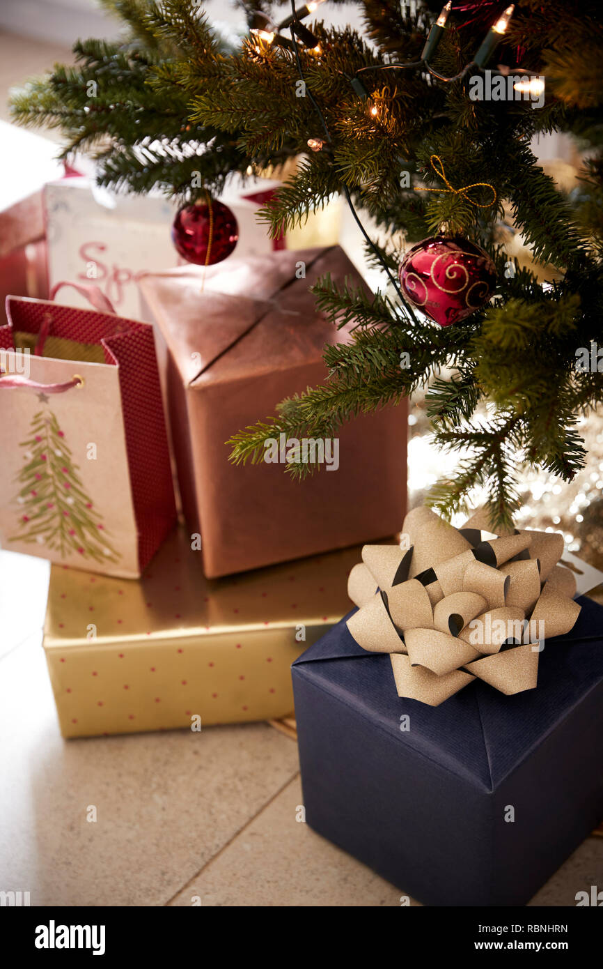 Gifts arranged under a decorated Christmas tree, close up Stock Photo