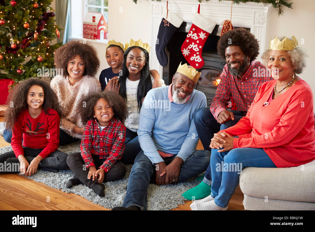 Portrait Of Multi Generation Family Sitting In Lounge At Home On Christmas Day Stock Photo