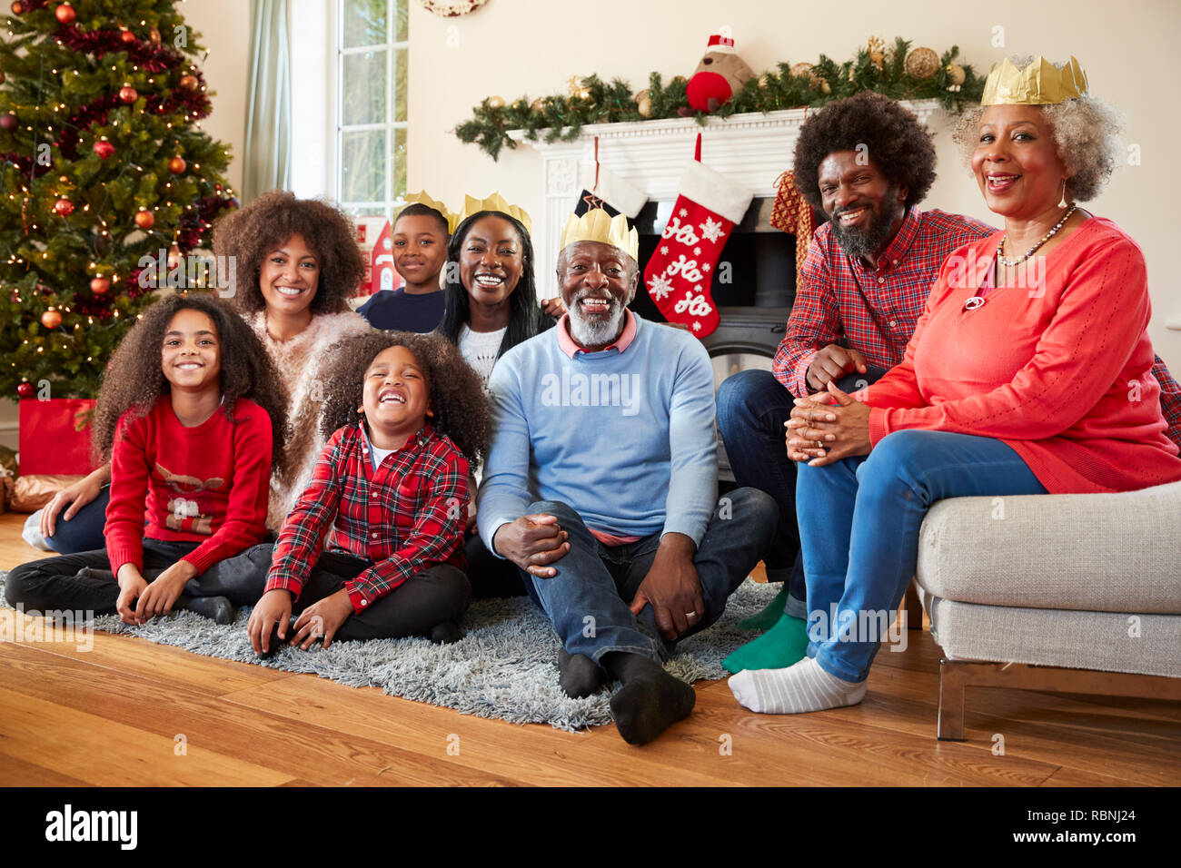 Portrait Of Multi Generation Family Sitting In Lounge At Home On Christmas Day Stock Photo