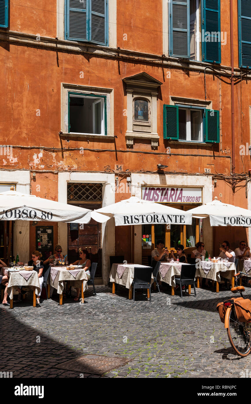 Tourists seated at tables outside the historic Hostaria dell' Orso restaurant in Rome, Italy. Stock Photo