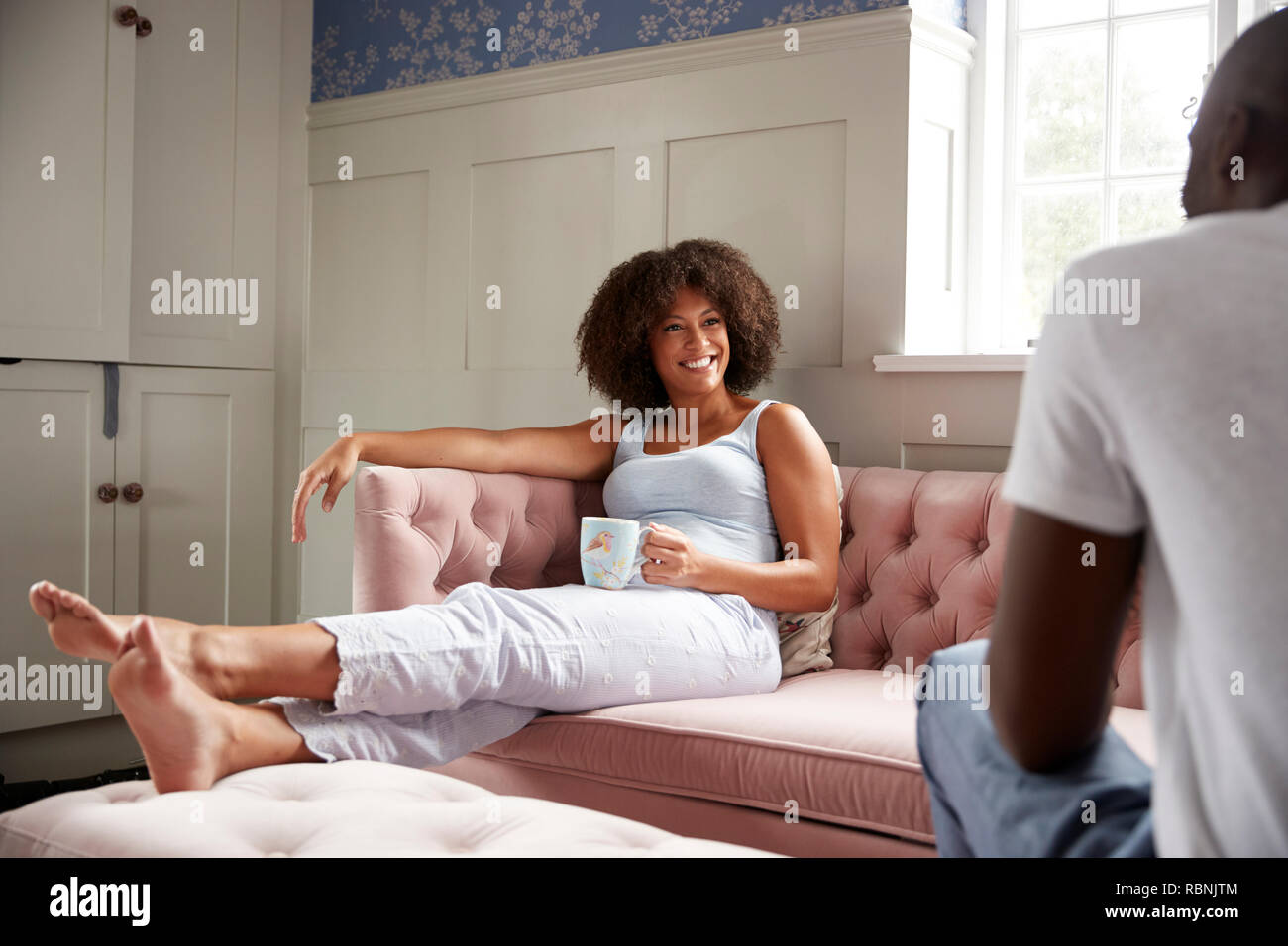 Young mixed race couple relax together drinking coffee in the morning, selective focus Stock Photo