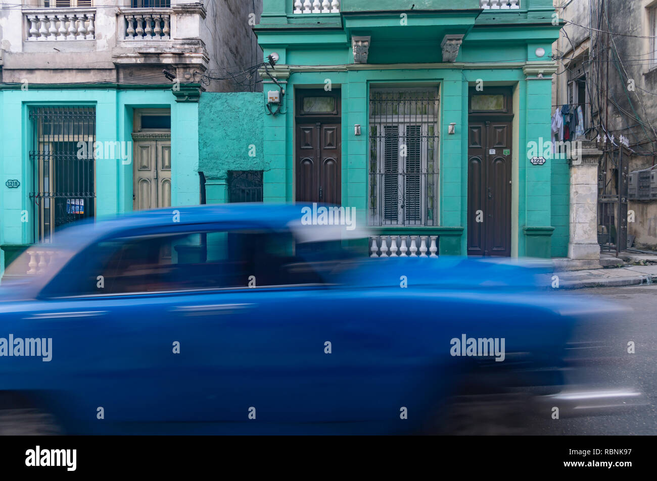 Old blue American car speeding along in Havana Cuba Stock Photo