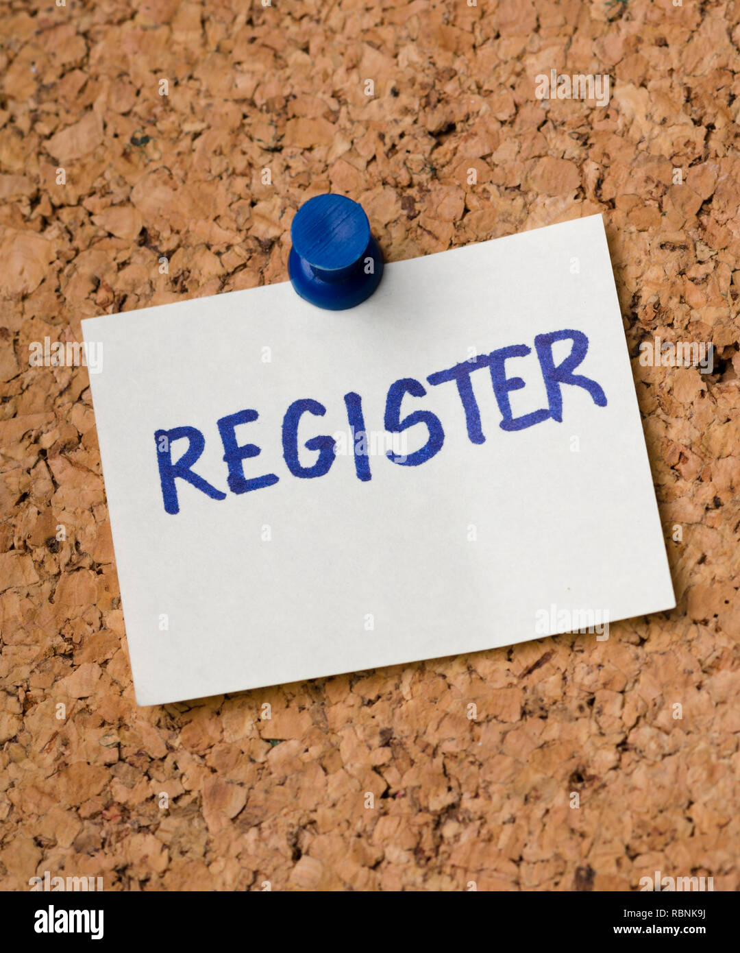 Register message on sticker note pin on cork office board. Reminder for ...