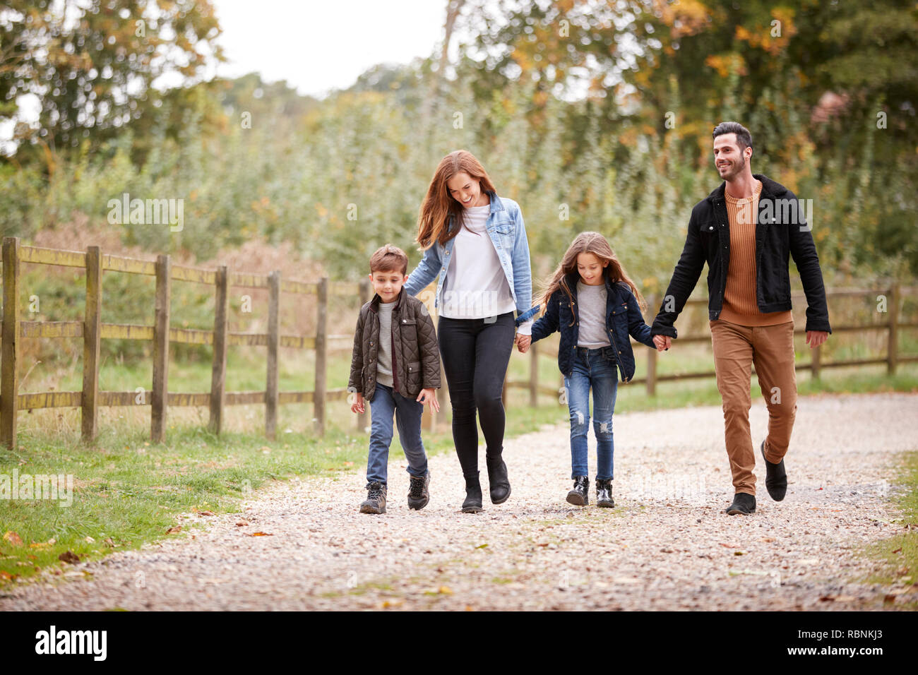 Family On Autumn Walk In Countryside Together Stock Photo