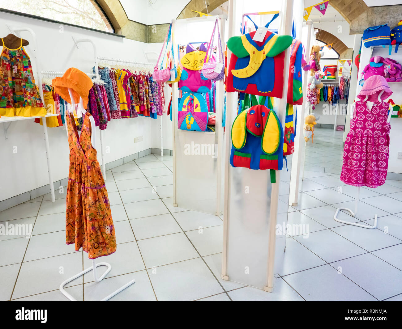 Puppet model on Cloth shop with cild colored clothes cotton bags