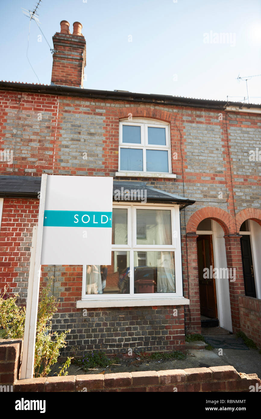 Real Estate Sold Board Outside Terraced House Stock Photo