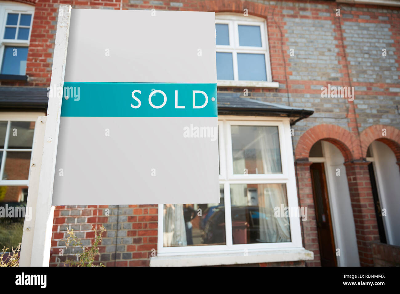 Real Estate Sold Board Outside Terraced House Stock Photo