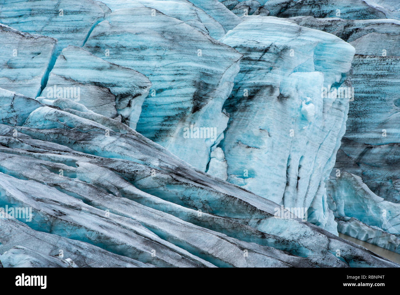 background of blue glacier ice formation with crevasses Stock Photo