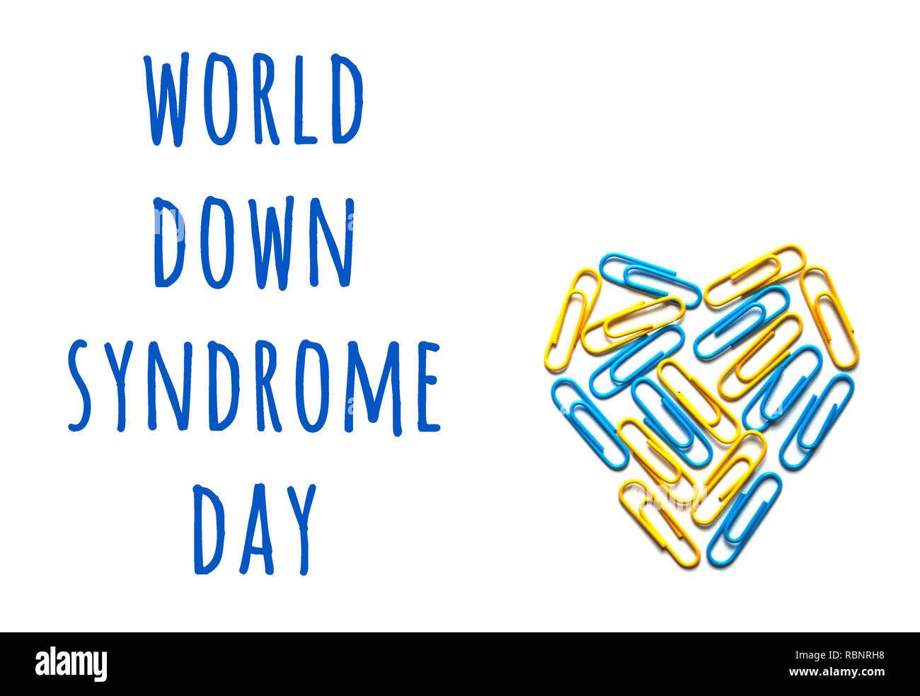 World down syndrome day. Down syndrome day concept with yellow and blue heart isolated on white background with copyspace. Stock Photo