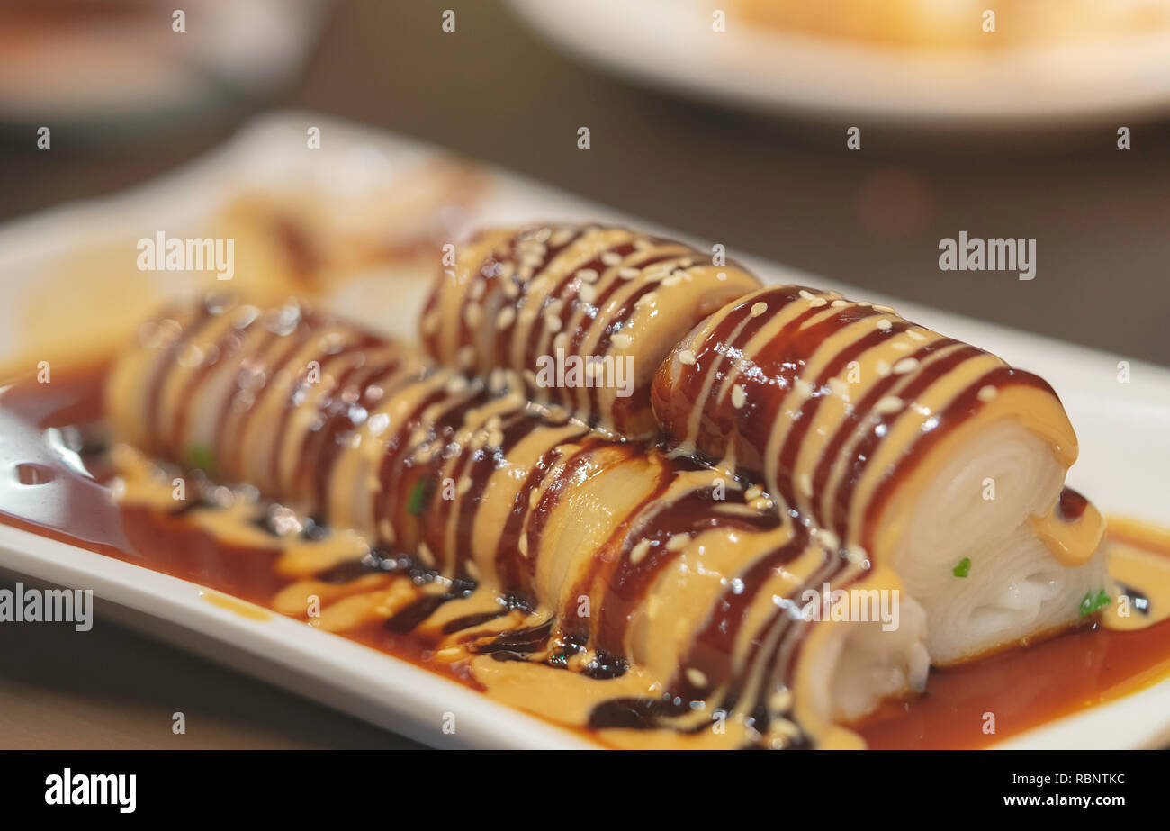 Chinese style rice noodles roll with sweet sesame sauce Stock Photo Alamy