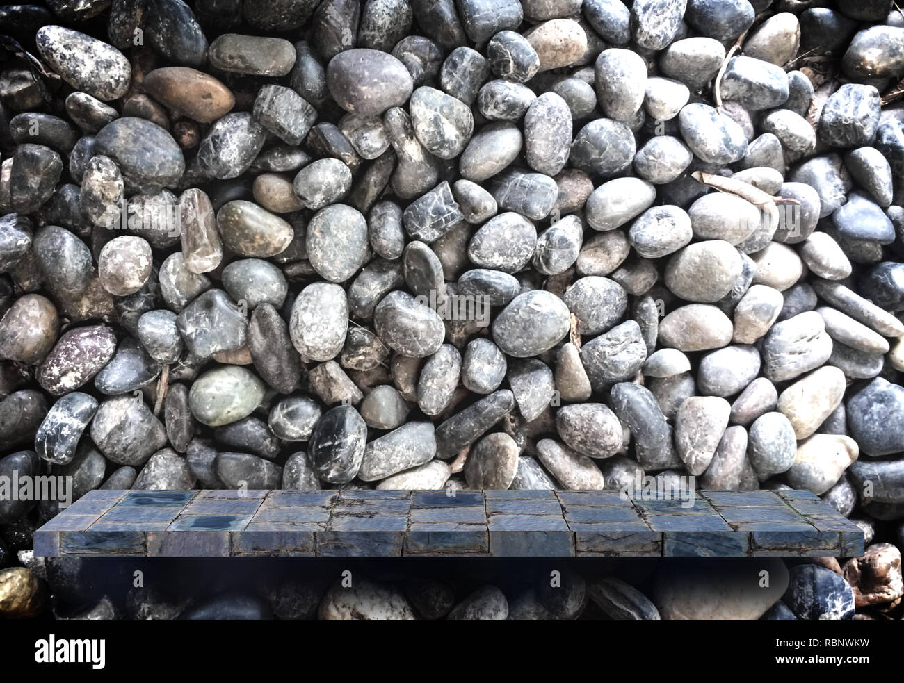 Empty blank stone display shelf on stone pebble background Stock Photo