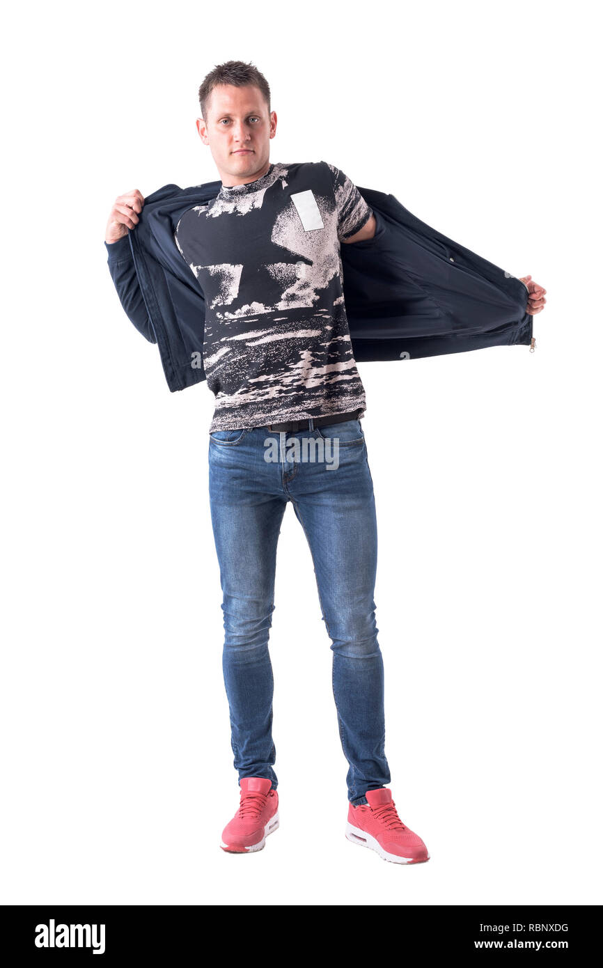 Young casual man removing bomber jacket looking at camera. Full body isolated on white background. Stock Photo