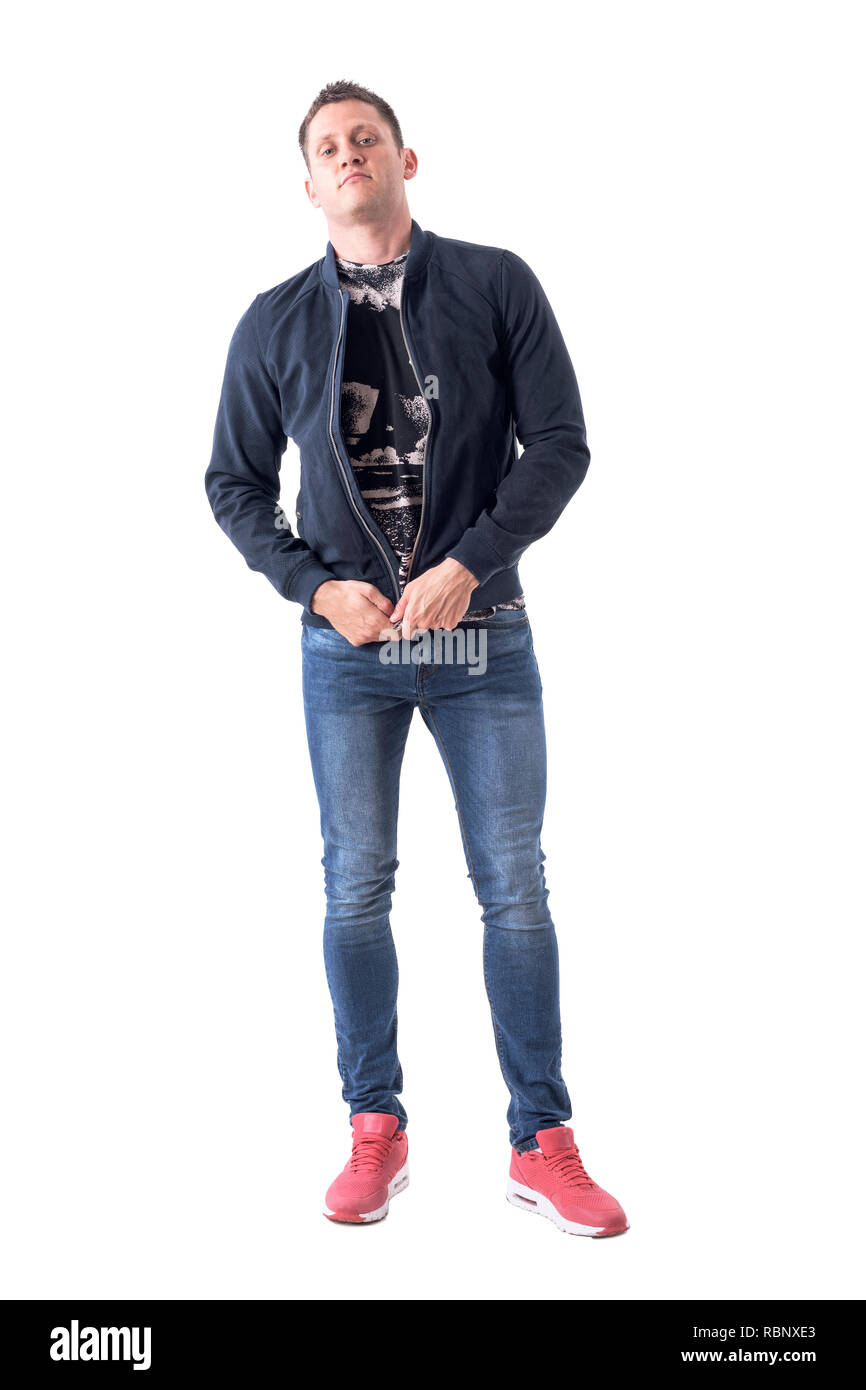 Serious macho adult casual man getting dressed zipping bomber jacket. Full body isolated on white background. Stock Photo