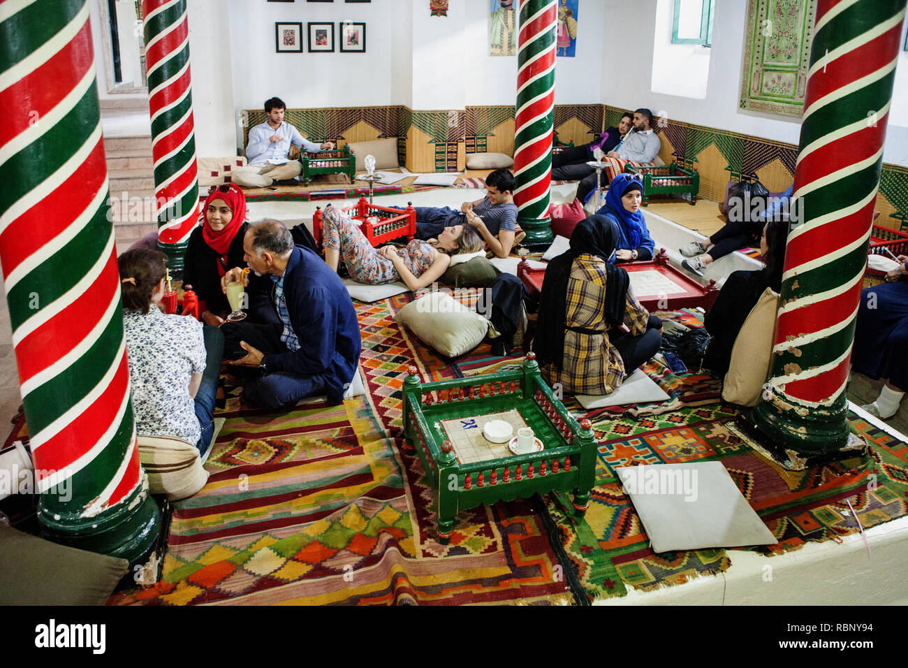 People are sitting and laughing at traditional cafe M'Rabet in Tunis ...