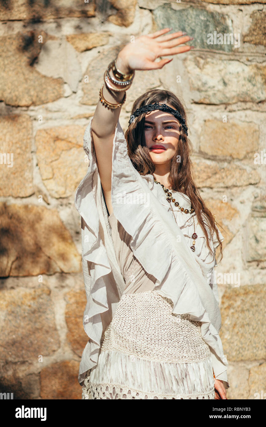 Fashion portrait of beautiful boho girl hiding from the sun with a hand on summer day Photo - Alamy