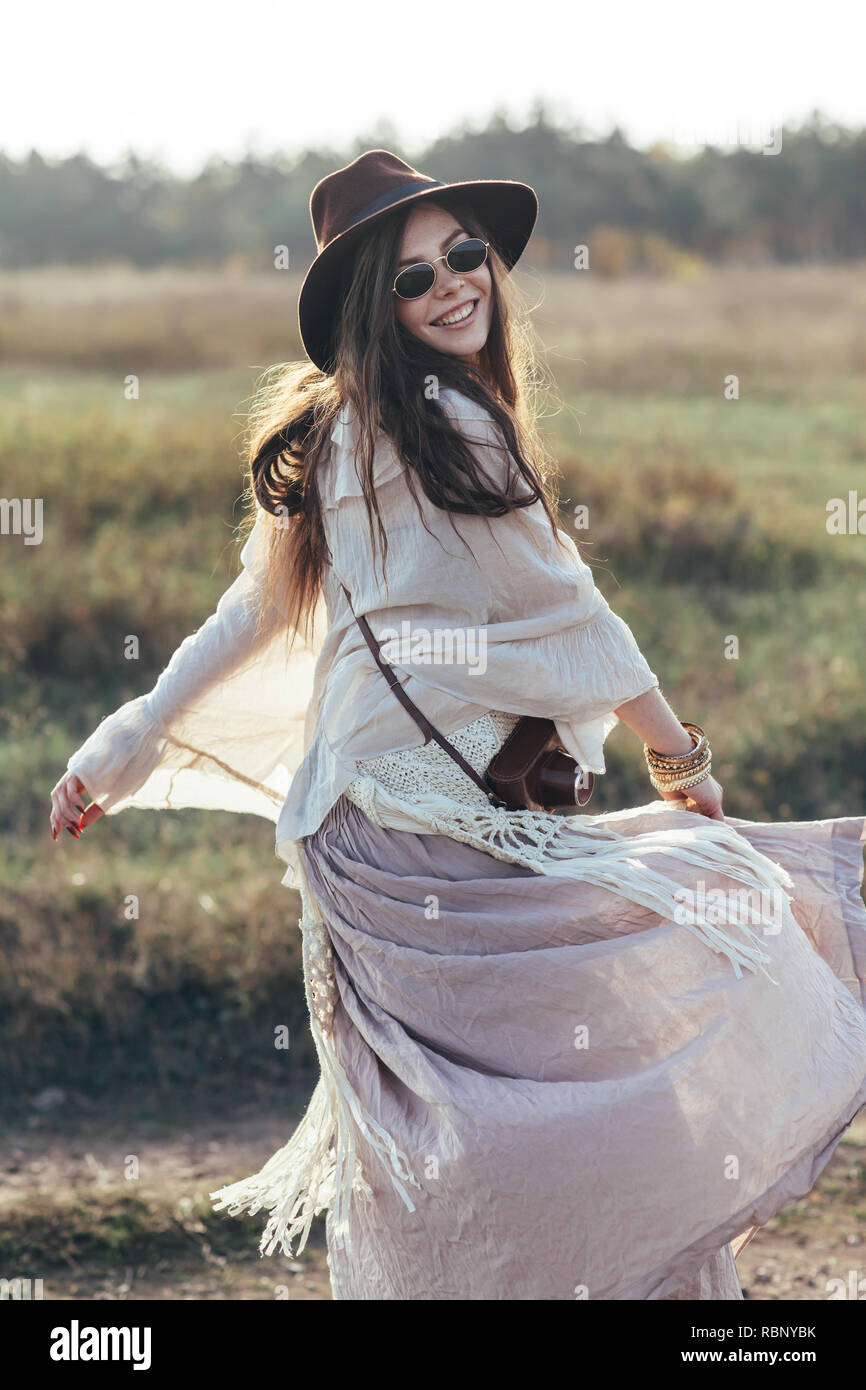 Beautiful hippie woman twirls and dancing outdoors. freedom woman spinning around Stock Photo