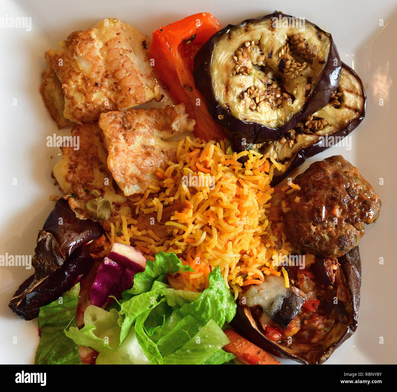 Rice and grilled vegetables and fish on a plate. Top view Stock Photo
