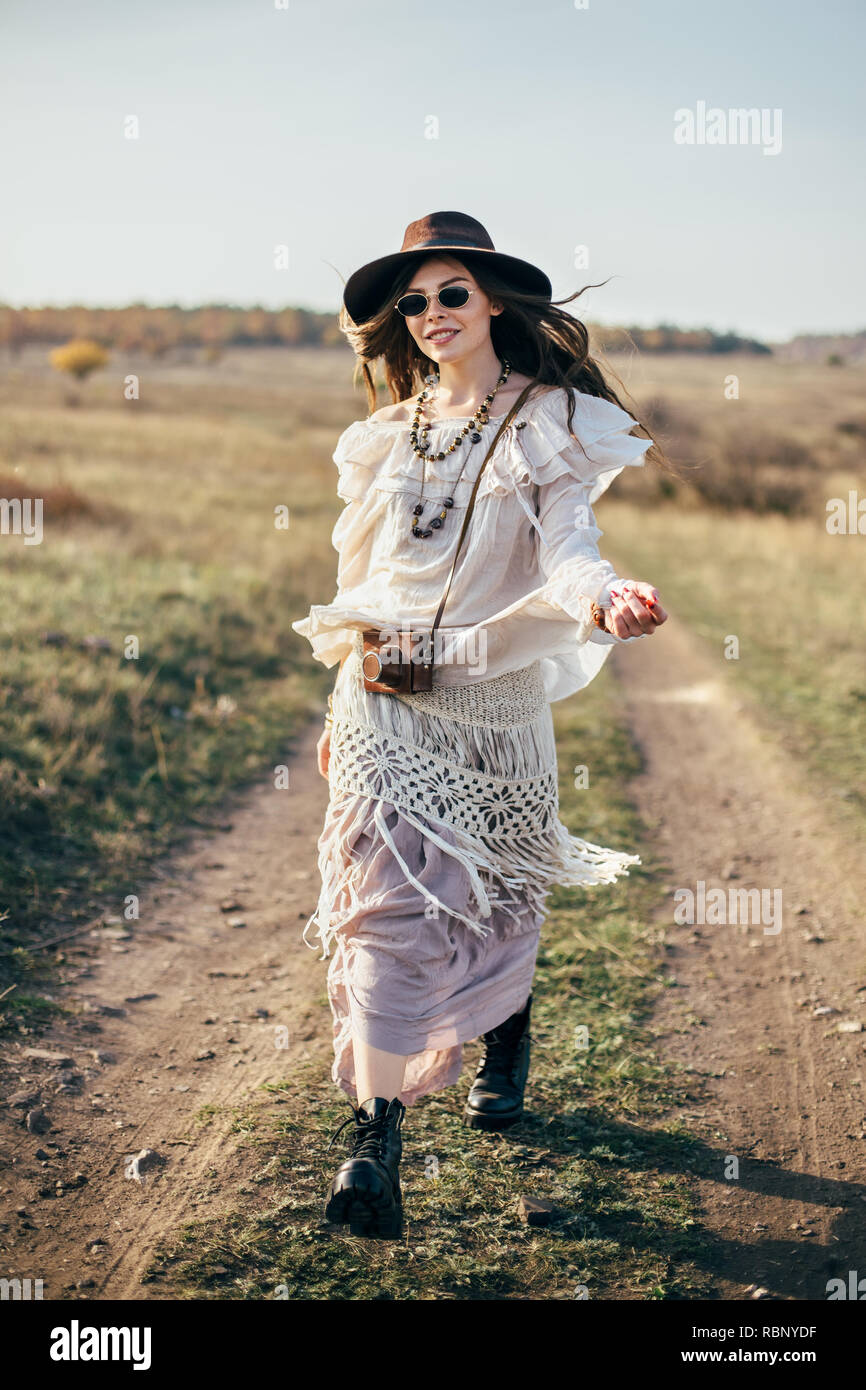 Portrait of young woman wearing boho clothes standing outdoors
