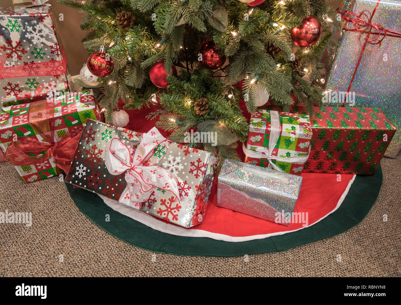 Christmas presents under a Christmas tree. Stock Photo