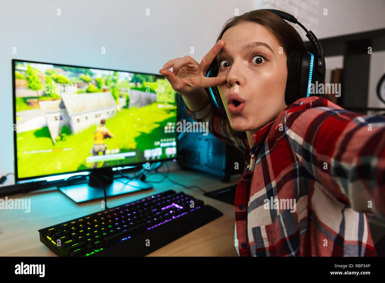 Excited Girl Gamer Sitting at the Table, Playing Online Games Stock Image - Image of headset, esports: 136171701