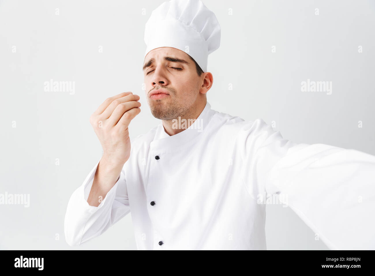 Happy chef cook wearing uniform standing isolated over white background