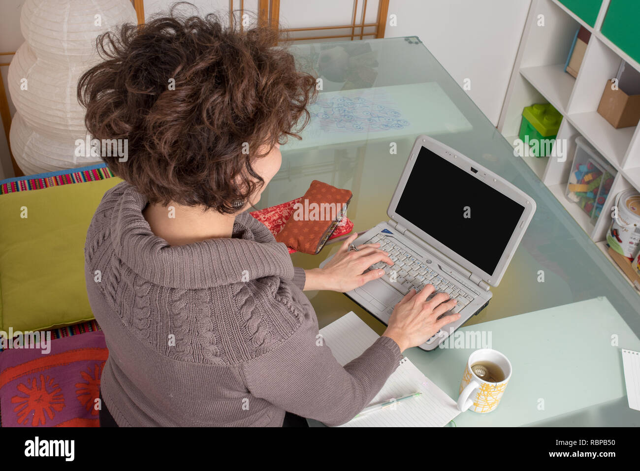 young woman studying on laptop computer, using e-learning method at ...