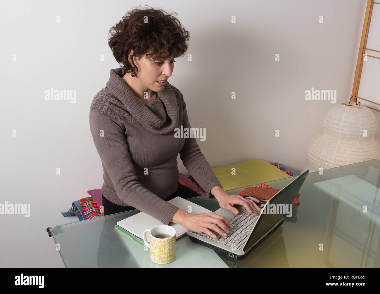 young woman studying on laptop computer, using elearning method at