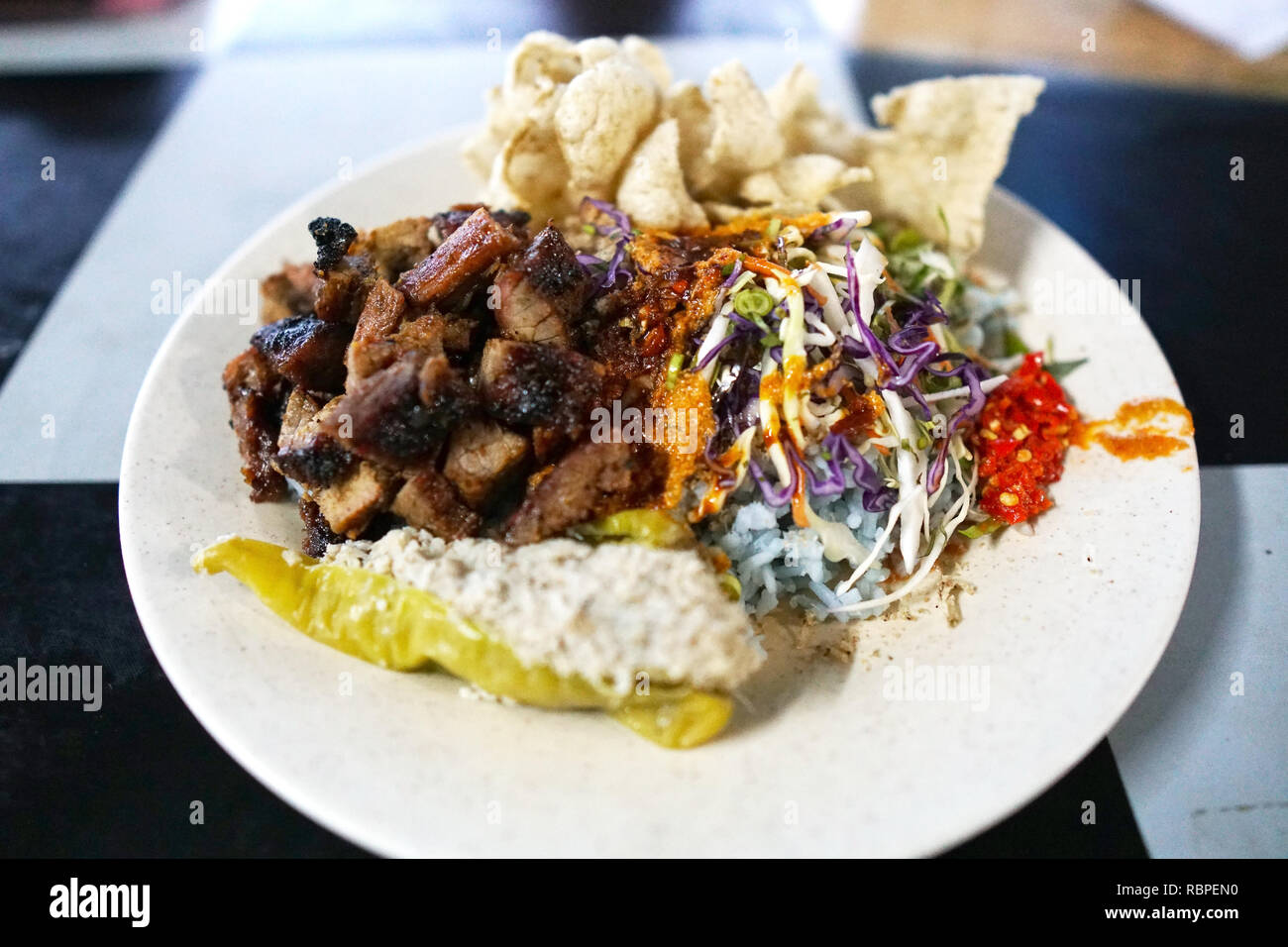 Nasi kerabu or nasi ulam, popular Malay rice dish. Blue color of rice ...