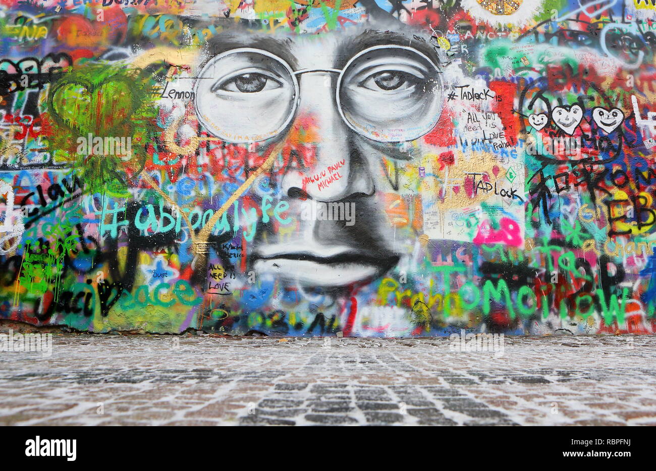 PRAGUE, CZECH REPUBLIC - JANUARY 04: The Lennon Wall since the 1980s is filled with John Lennon-inspired graffiti and pieces of lyrics from Beatles. Stock Photo