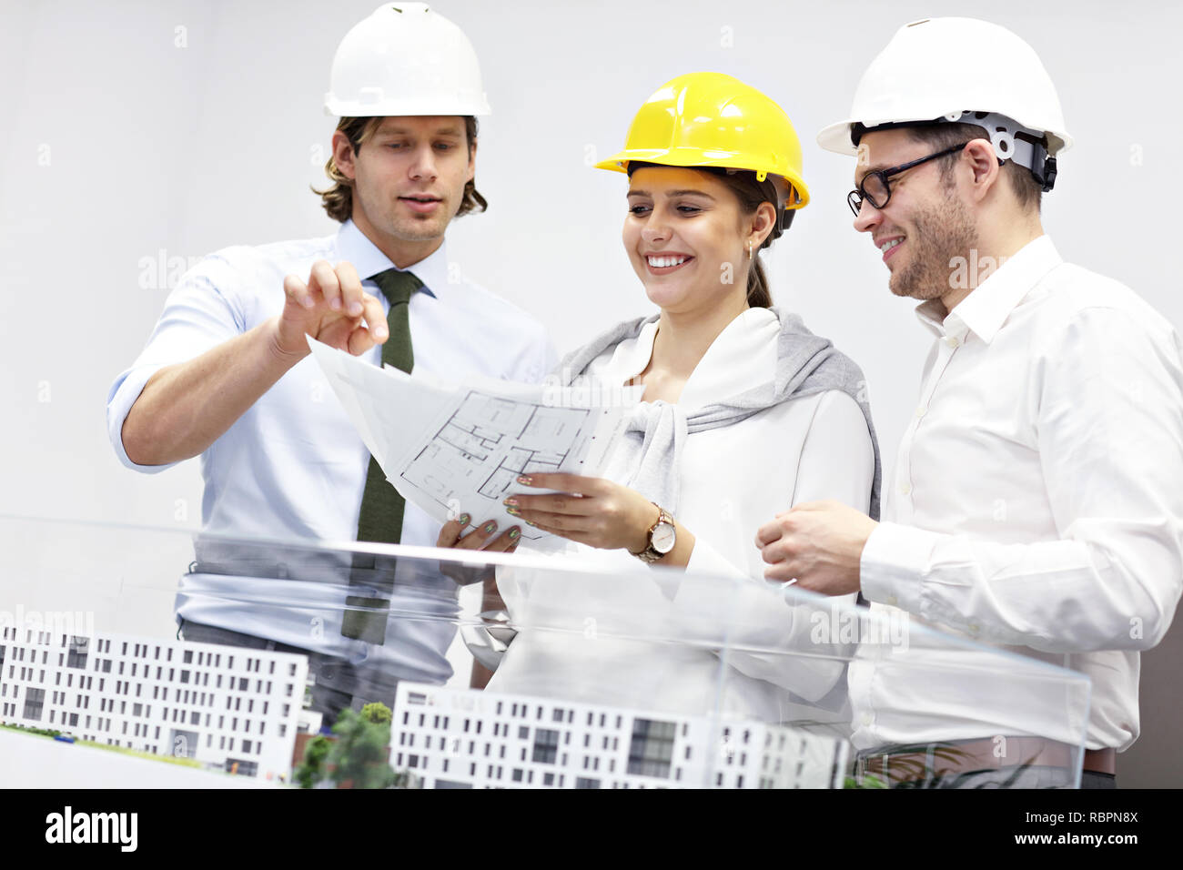 Group of architects sharing ideas in modern office Stock Photo
