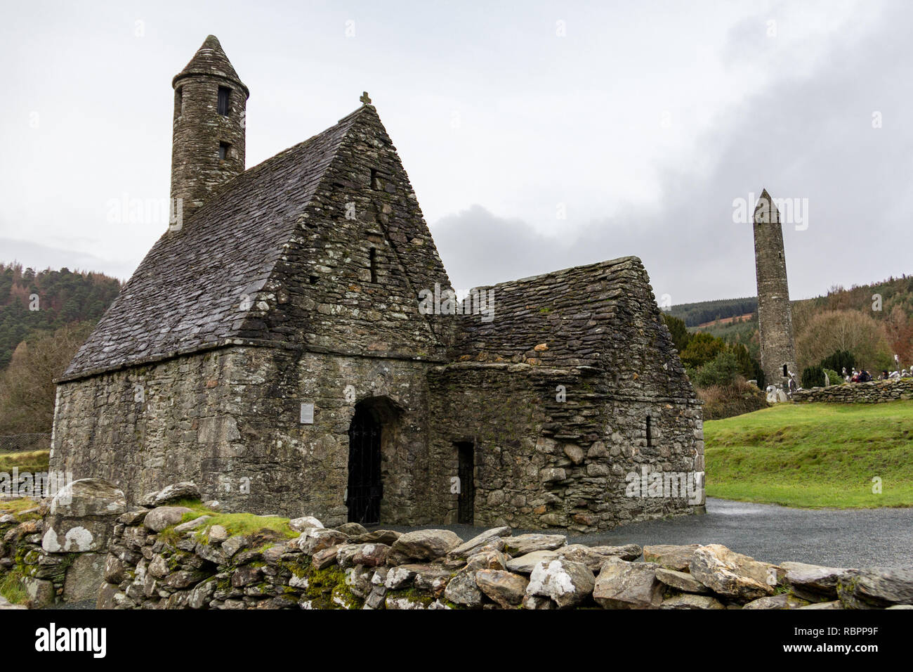 Saint Kevin's Kitchen and the Round Tower at the Glendalough Monastic Site in Wicklow, Ireland Stock Photo