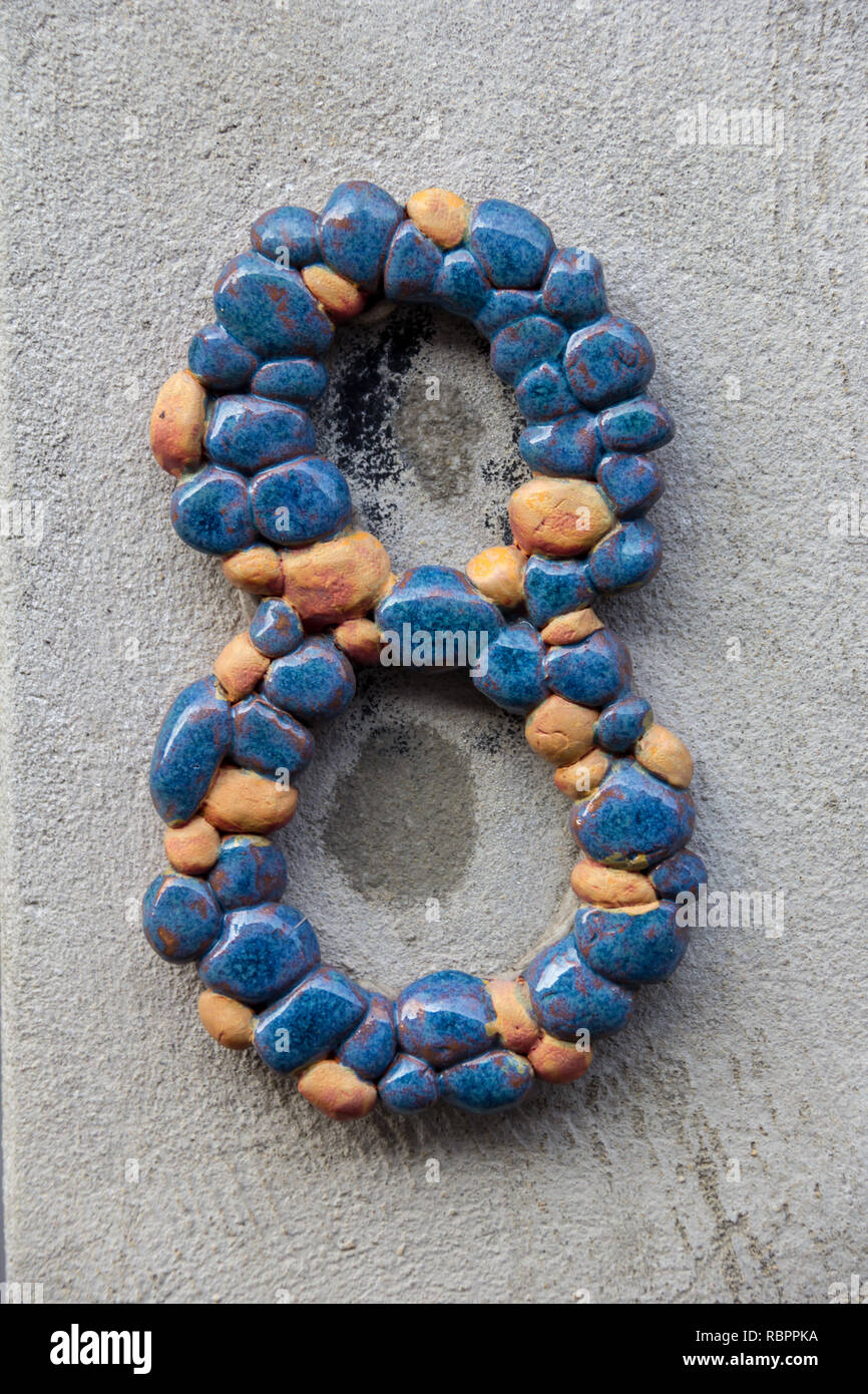 A Decorative House Number Eight Consisting Of Blue And Orange