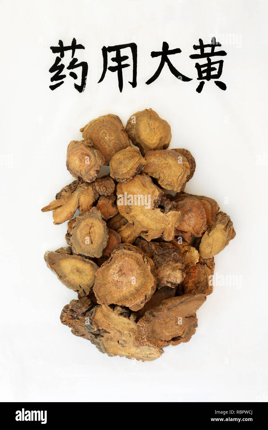Rhubarb root herb used in chinese herbal medicine with calligraphy script, used as a laxative, regulates weight loss & helps to treat type 2 diabetes. Stock Photo