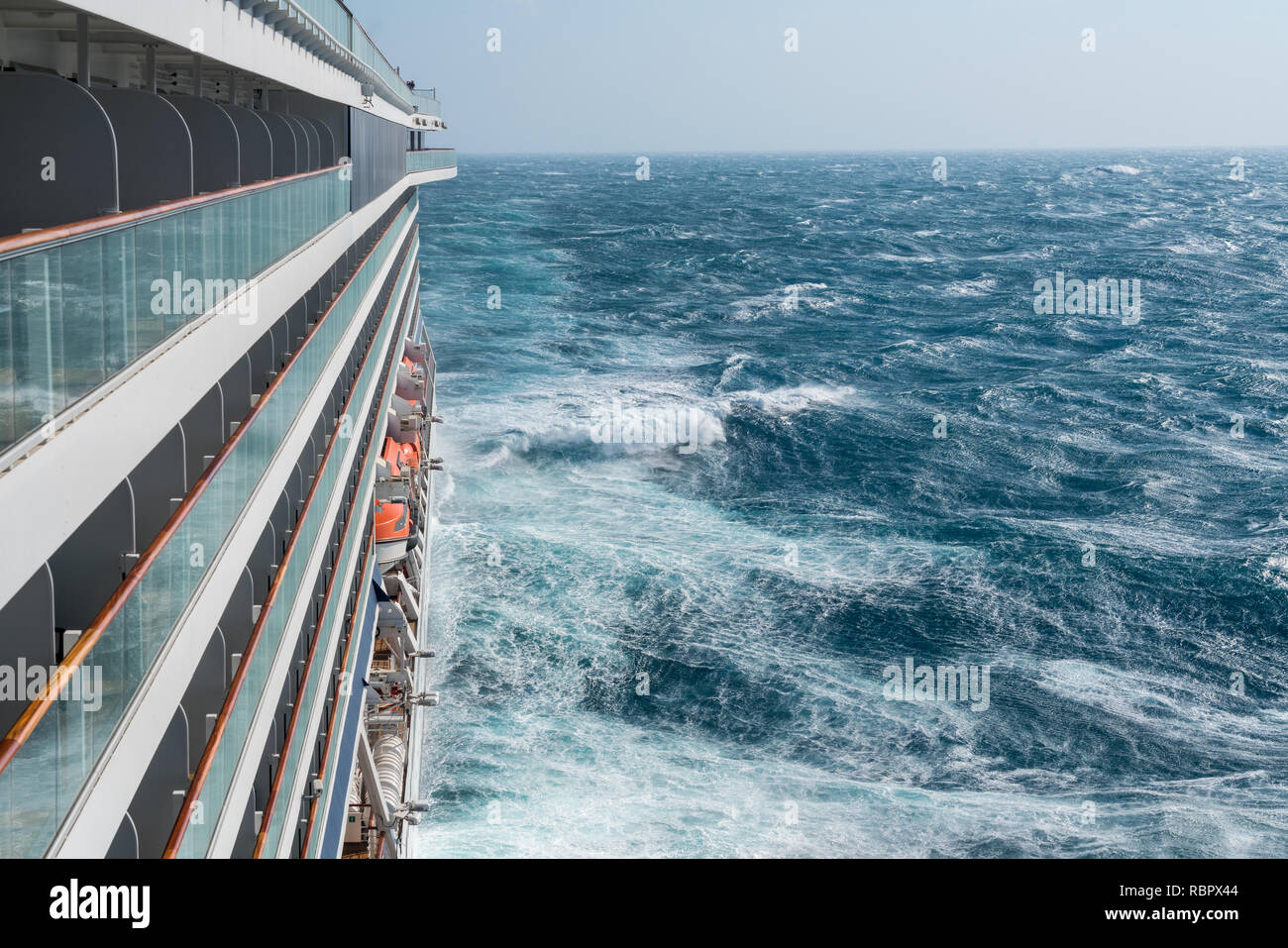 Modern cruise ship traveling through rough seas Stock Photo