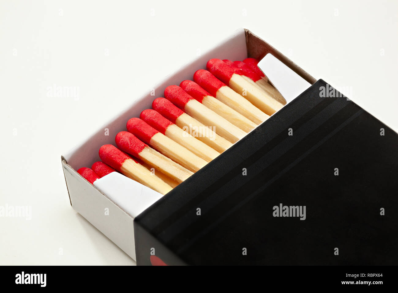 Open cardboard matchbox filled with matches on a white background Stock Photo