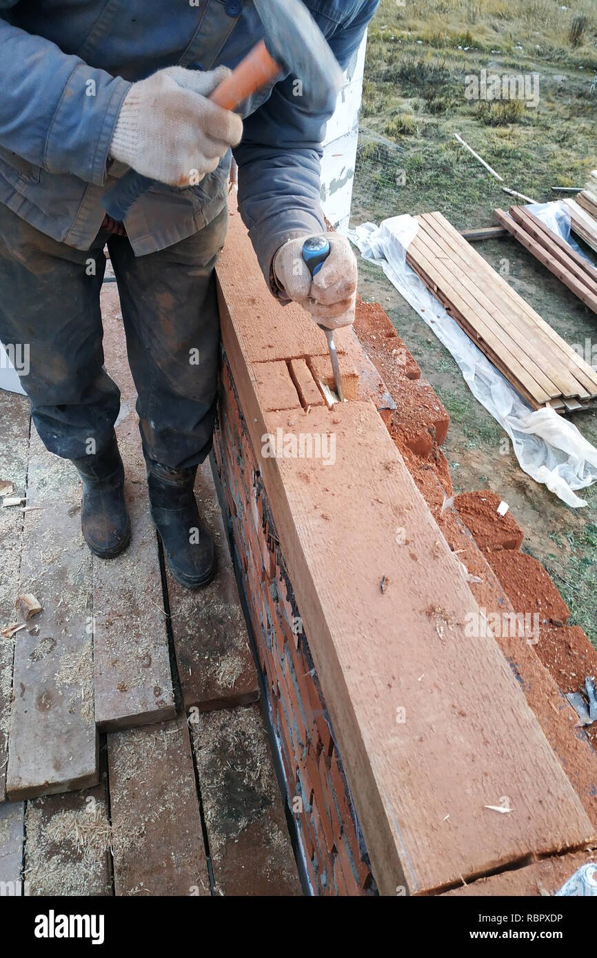 The wizard uses a bit to grind wood in the building 2018 Stock Photo