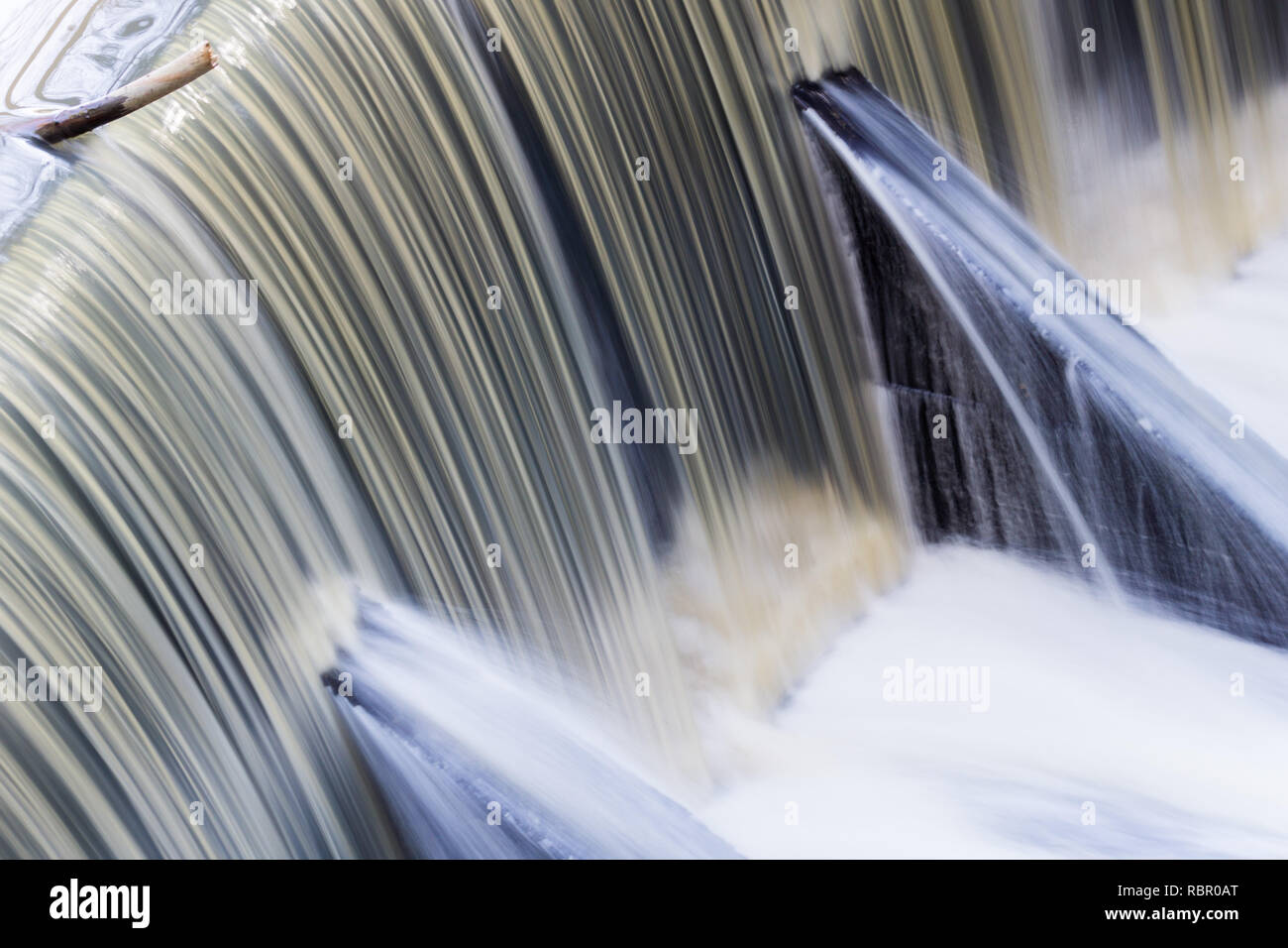 Fast flowing water over a concrete dam, California; long exposure Stock Photo