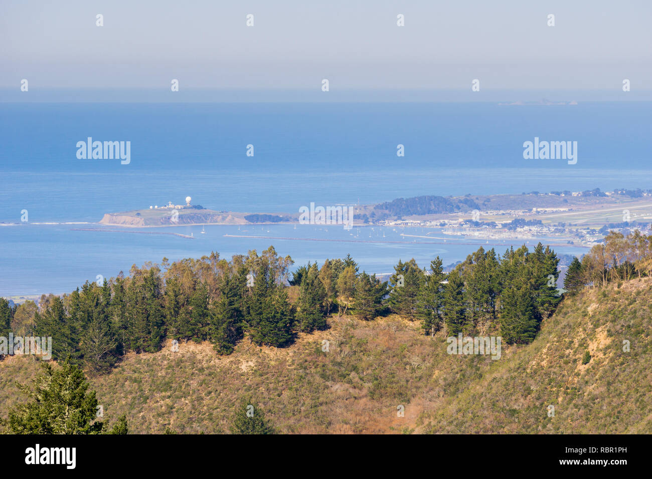 View towards the Pacific Ocean and Pillar Point Harbor from Purisima Creek Redwoods Park on a clear day; Farallon Islands visible, California Stock Photo