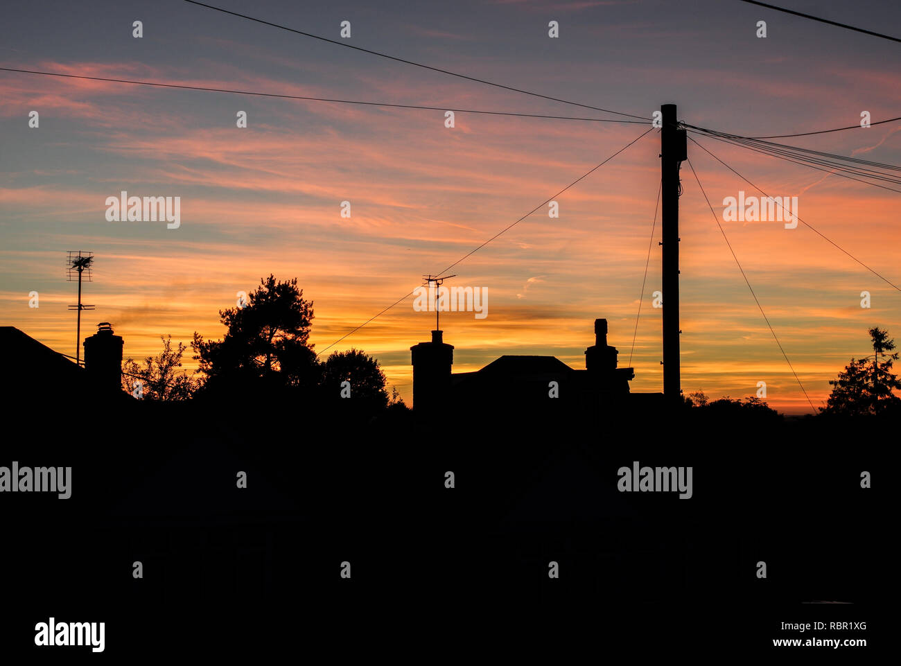 Sun setting behind the neighbourhood in Burgess Hill, West Sussex Stock Photo