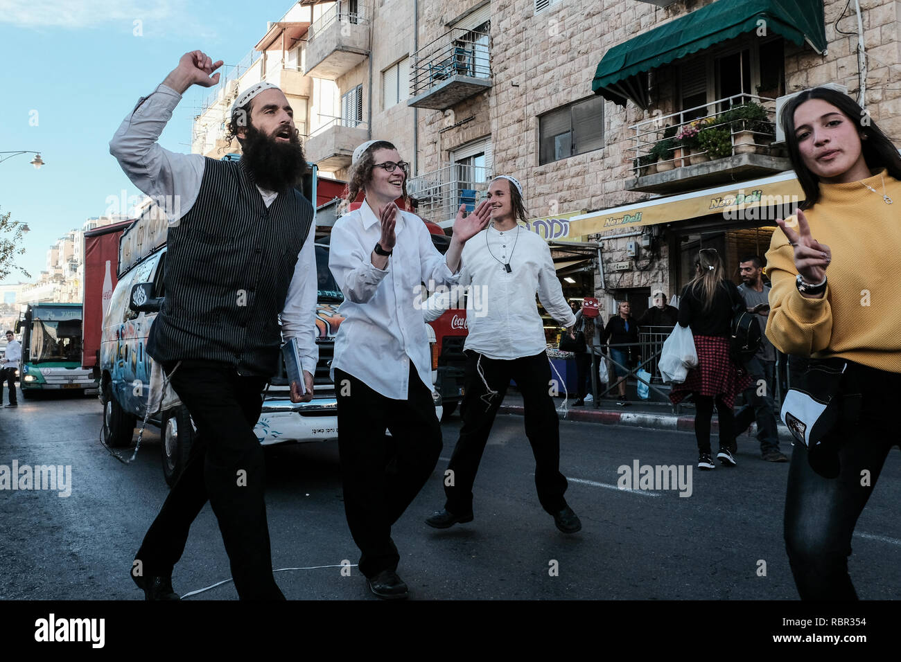 Faithful followers of Rabbi Nachman of Breslov break out in song and dance on Agripas Street adjacent to Mahane Yehuda Market. Mahane Yehuda, often re Stock Photo