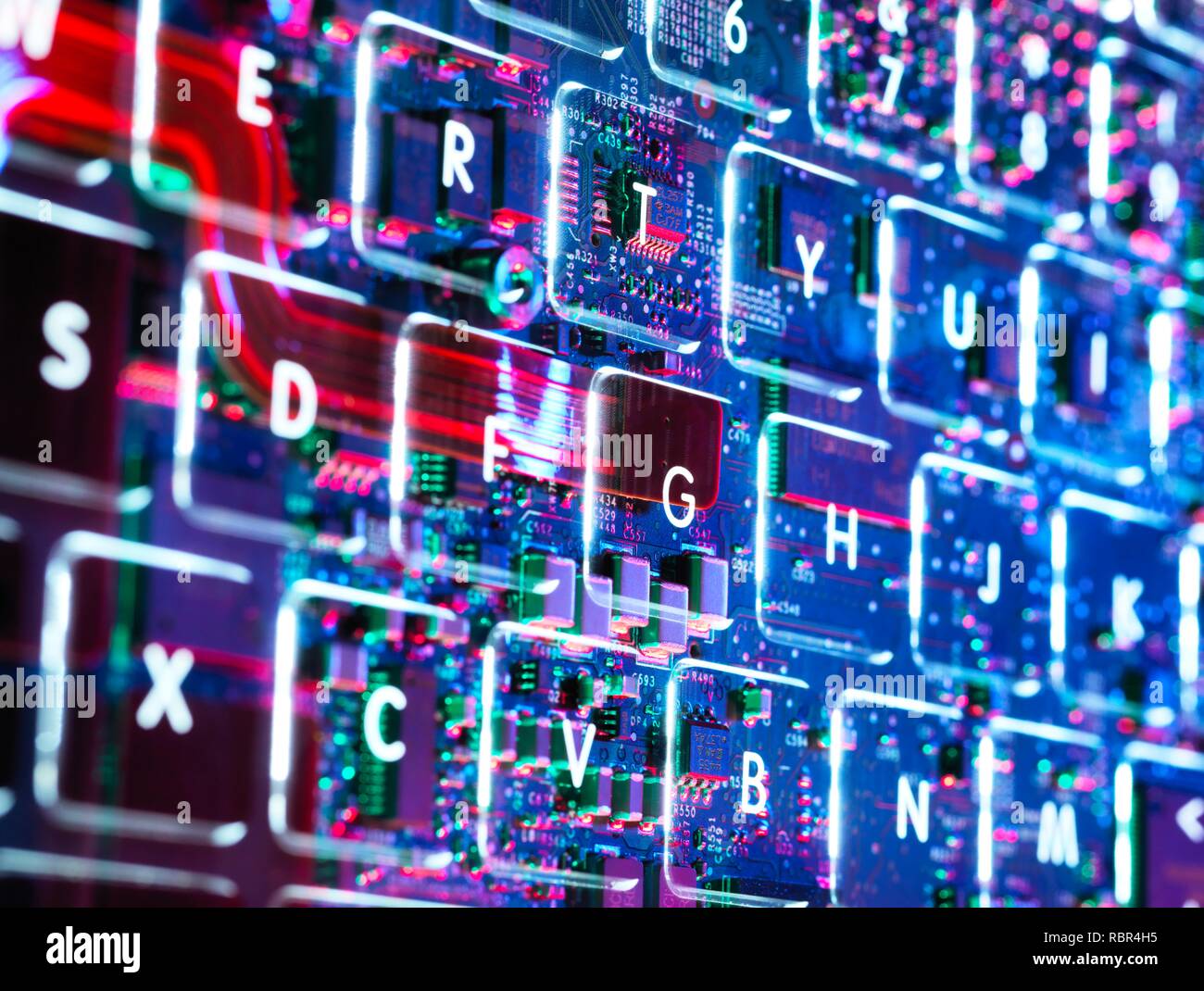 Double exposure of a laptop computer keyboard showing the electronics underneath. Stock Photo