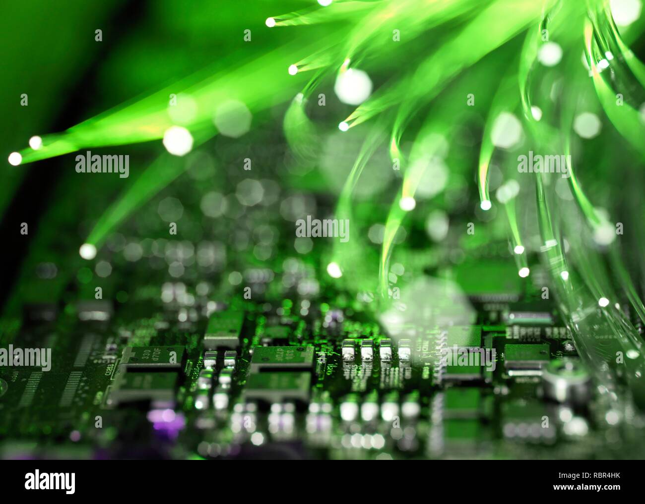 Fibre optics carrying data over electronic circuitry on a laptop computer. Stock Photo