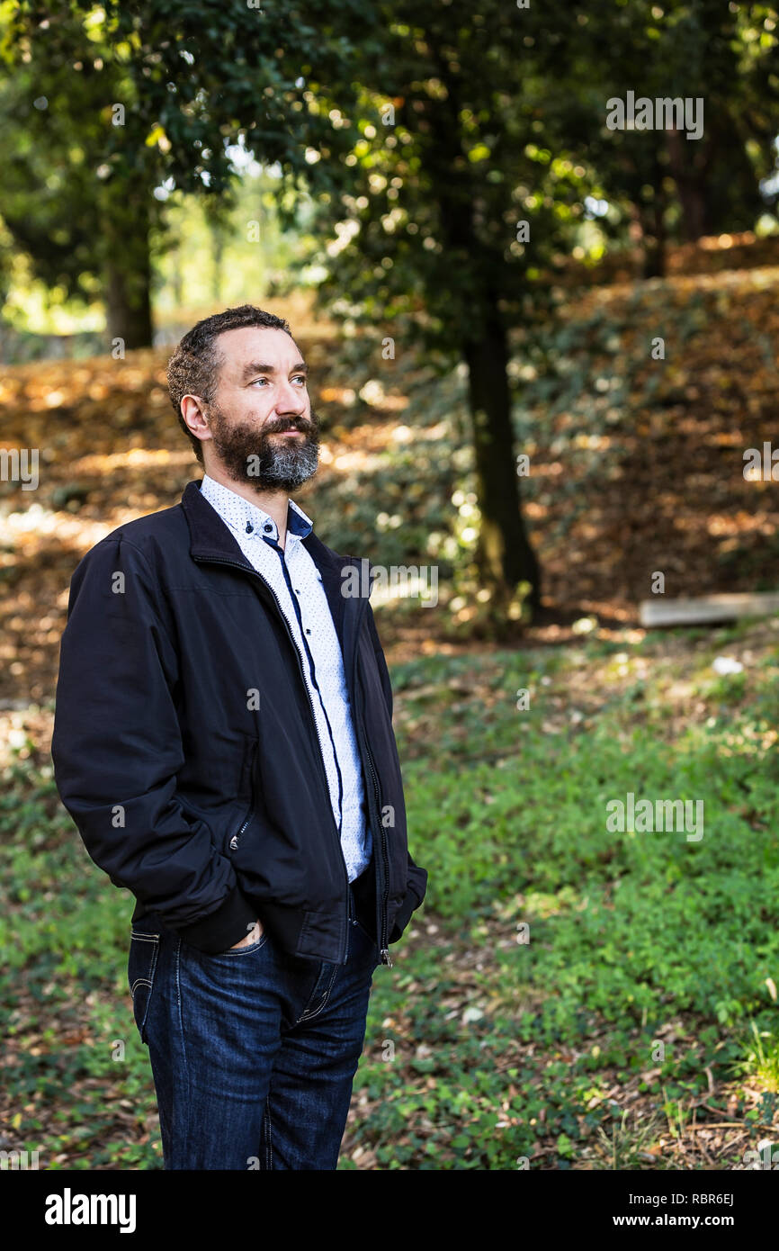 Portrait Of Handsome 40 Year Old Man With Curly Hair And Grizzled