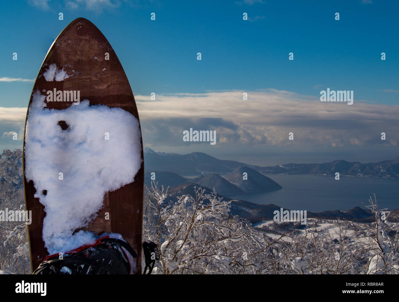 A Gentem Snowsurf board in the foreground with Lake Toya in the background at Rusutsu Ski Resort, Hokkaido, Japan. Stock Photo