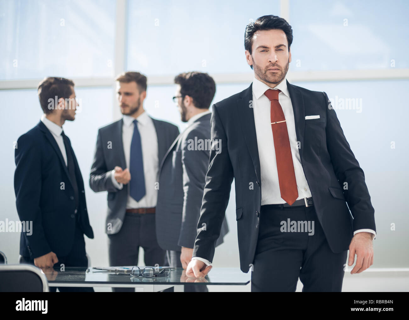 serious businessman standing in the office Stock Photo - Alamy
