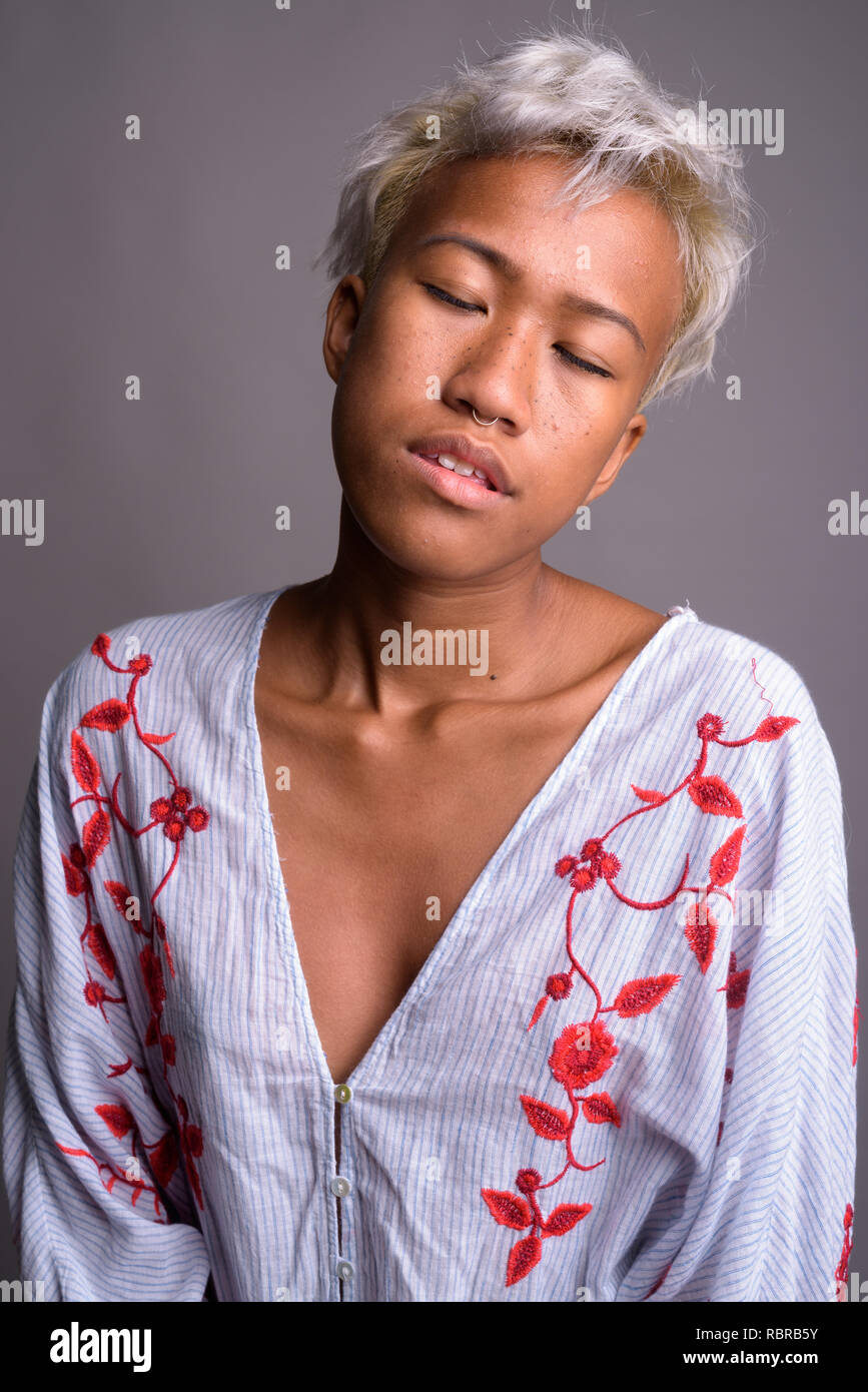 Young beautiful woman with short hair relaxing with eyes closed Stock Photo