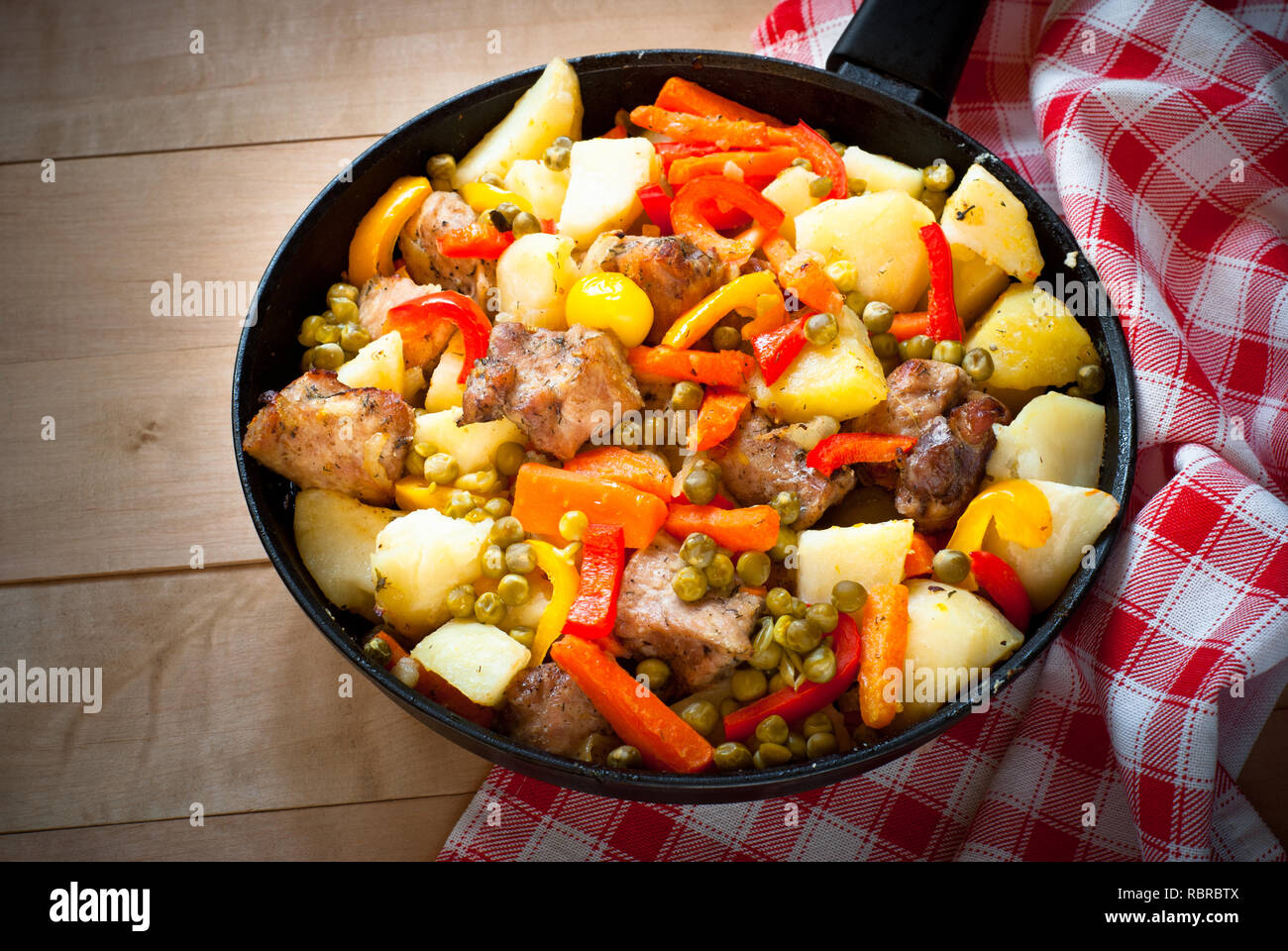 Meat with vegetables. Food in the frying pan. Main dish. Stock Photo