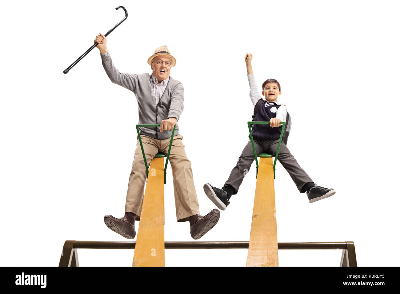 Cheerful grandpa and his grandson having fun on a seesaw isolated on white background Stock Photo