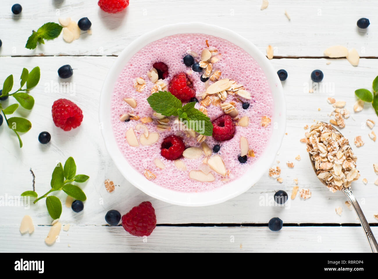 Yogurt with berries. Homemade yogurt or whipped milk shake with fresh berries. Serve with berries, almond flakes and oat flakes. Stock Photo