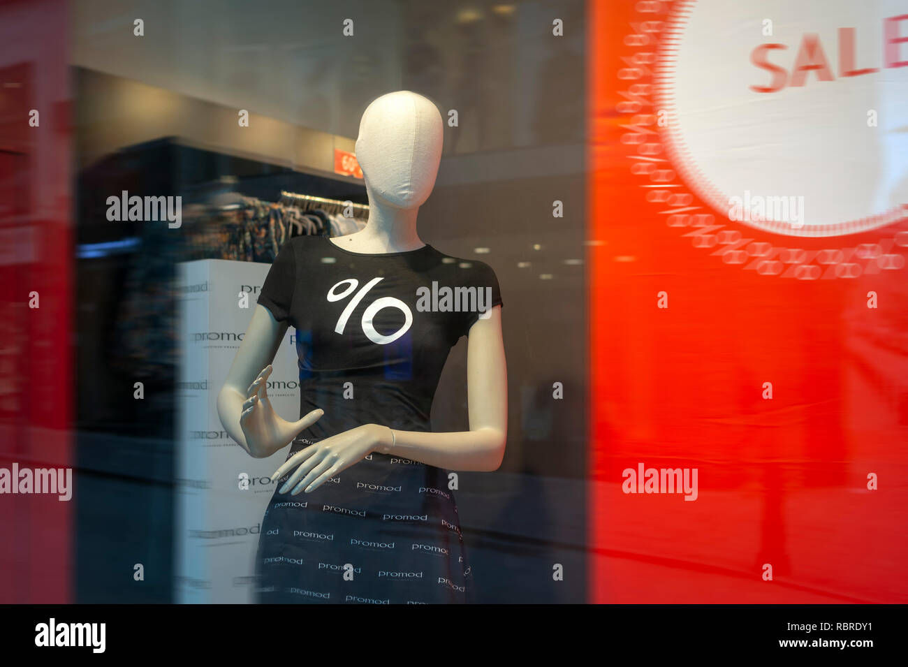 female mannequin in a shop window, sale % Stock Photo